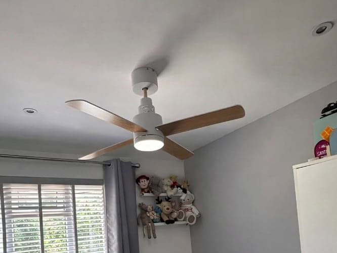 Ceiling fan with a built-in light fitted in a child's bedroom