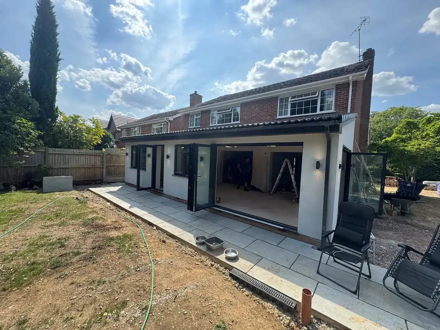 Finished rear extension with bifold doors and outdoor wall lights, wired from first fix to second fix