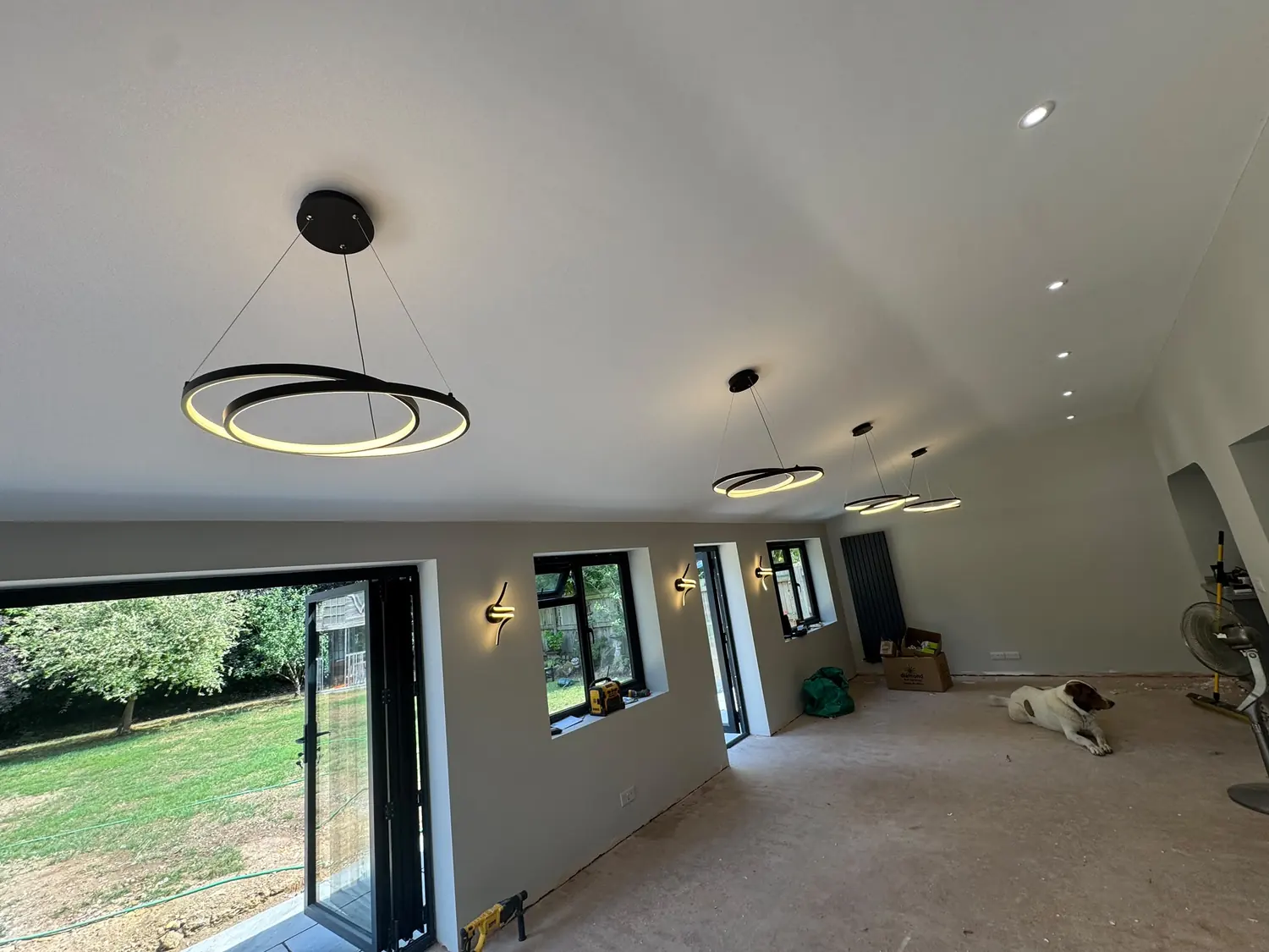 Ring pendant lighting over an open-plan kitchen island by Protec Elec Ltd